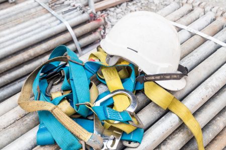 safety-helmet-and-safety-harness-at-a-construction-P87EPBK